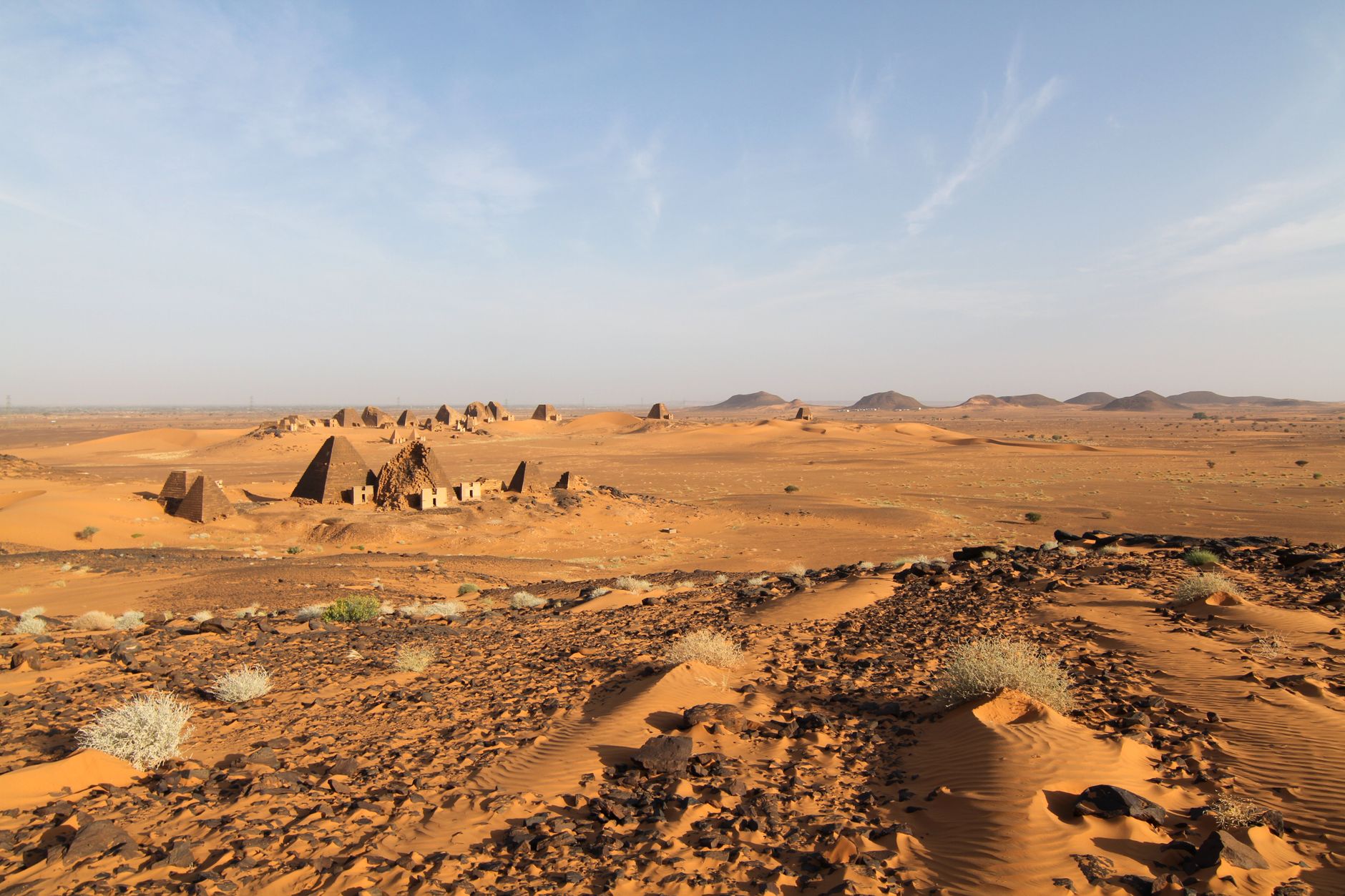 Explore the ancient pyramids of Meroë against the vast desert landscape in Sudan.