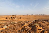 Explore the ancient pyramids of Meroë against the vast desert landscape in Sudan.