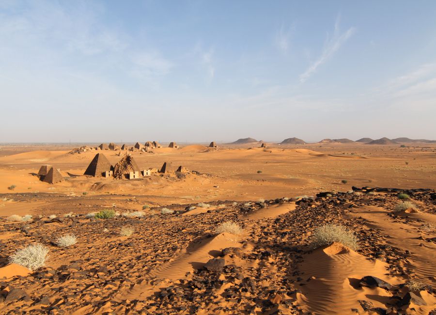 Explore the ancient pyramids of Meroë against the vast desert landscape in Sudan.