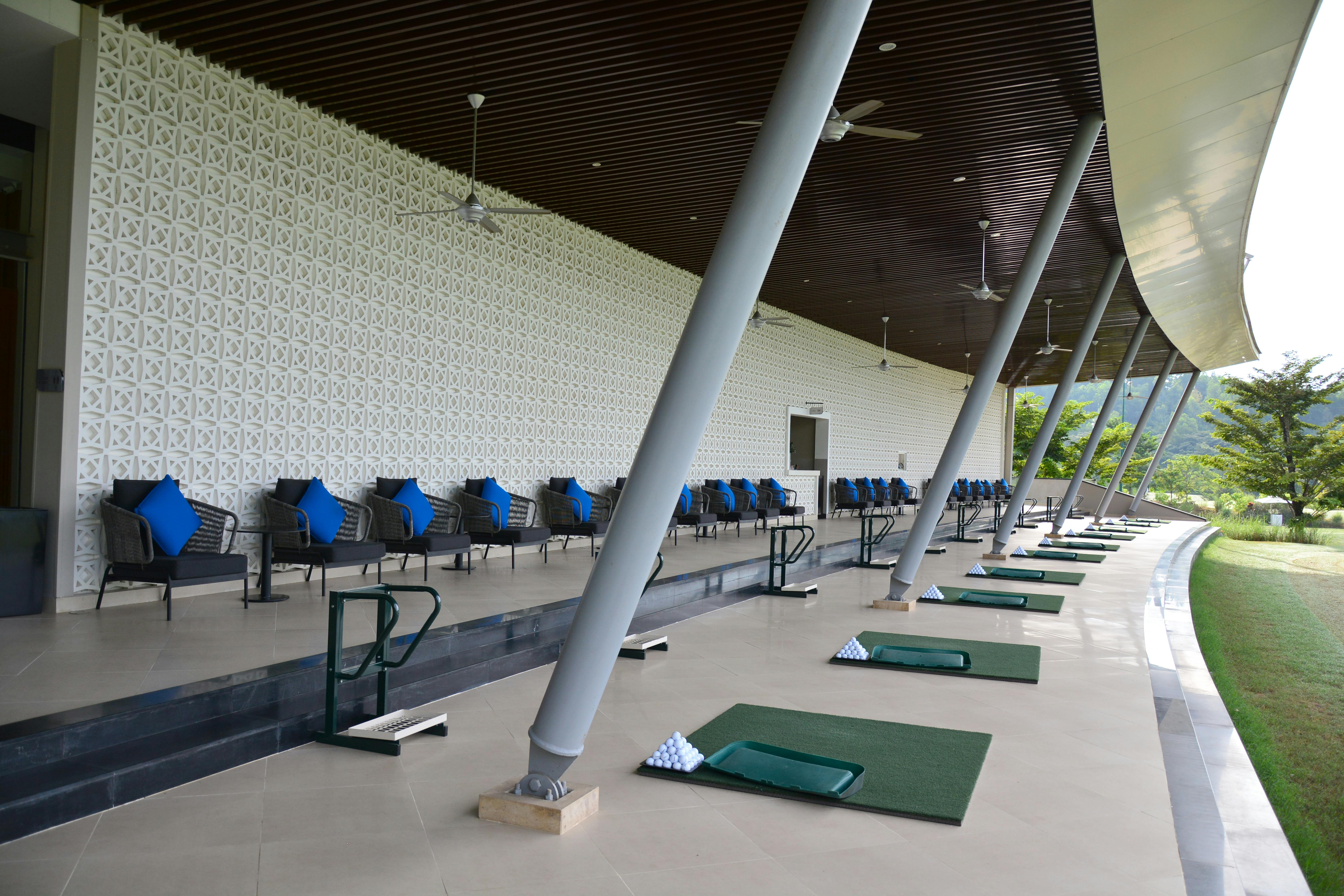 a driving range with golf balls on golf mats