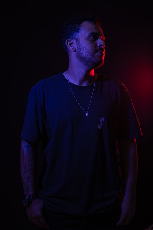 Free Artistic portrait of a man with dramatic colored lighting on a black background. Stock Photo