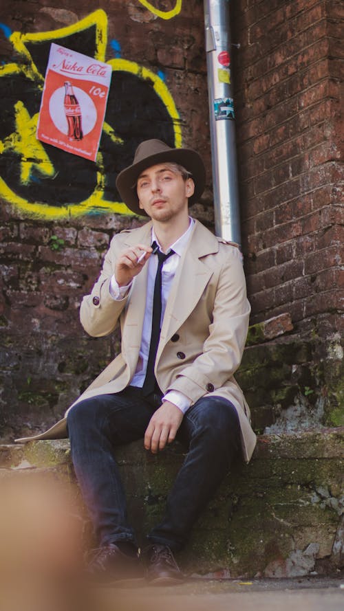 Free Photo of a Man in a Beige Coat Smoking a Cigarette Stock Photo