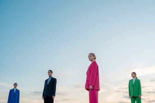 Women in Colored Suits against Sky