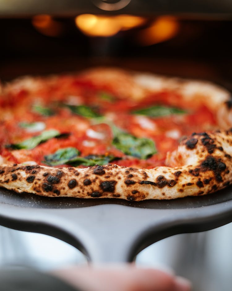 A Close-up Of A Pizza On A Pizza Peel