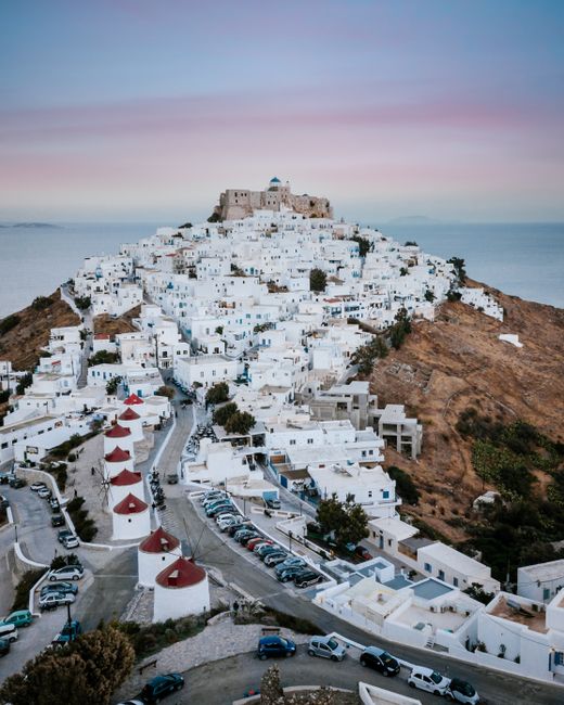 A stunning aerial shot of Astypalaia's white-washed buildings against a twilight sky, ideal for travel enthusiasts.