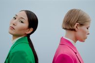 Woman in Green Shirt Kissing Girl in Pink Shirt