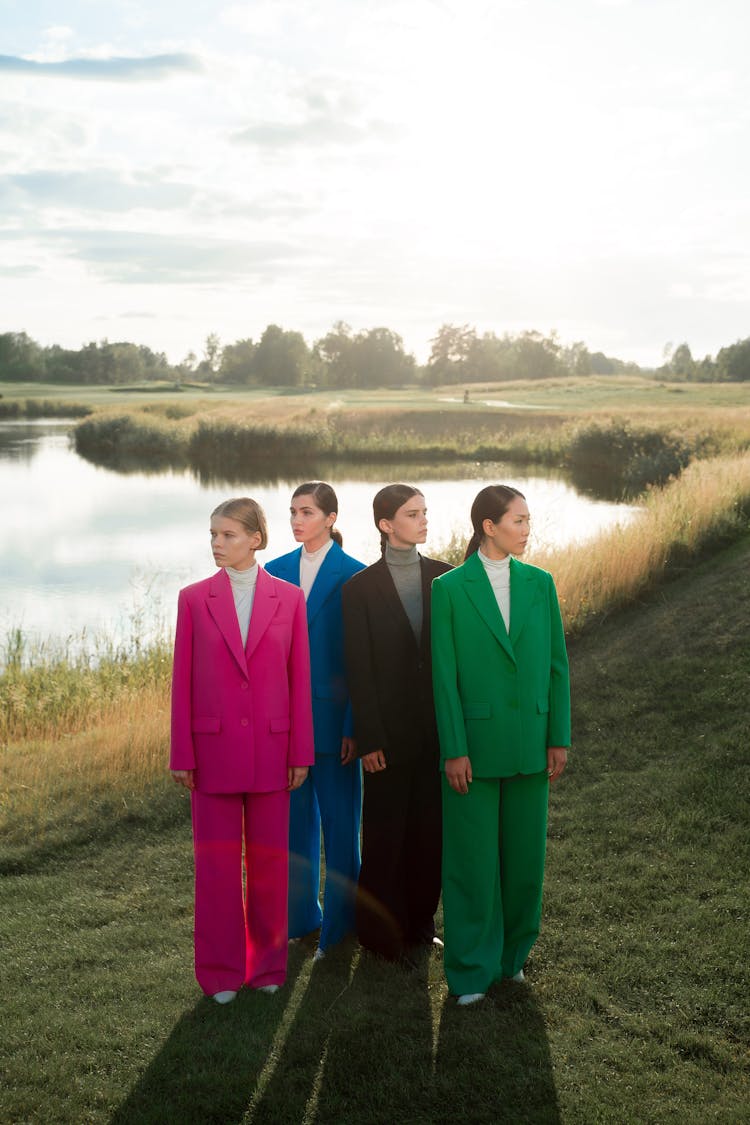 Four Women Wearing Blazers And Trousers In Different Colors