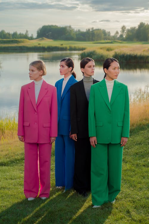 Group of Women Wearing Blazers and Trousers in Different Colors