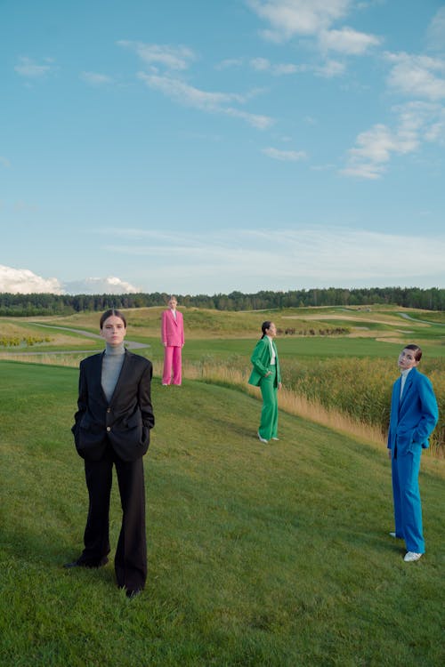 Women in Colored Suits in Meadow
