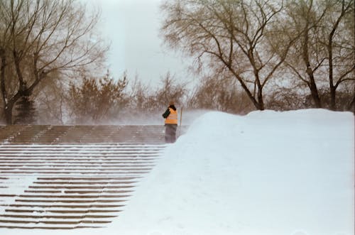 Photo of a Man Standing on the Stairs During Winter