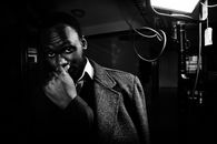 Man in Black Suit Jacket Smoking Cigarette