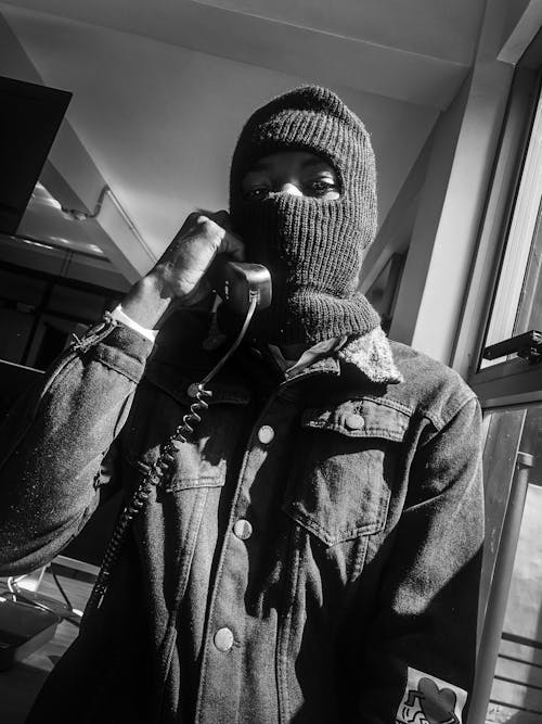 Man in Balaclava and with Telephone