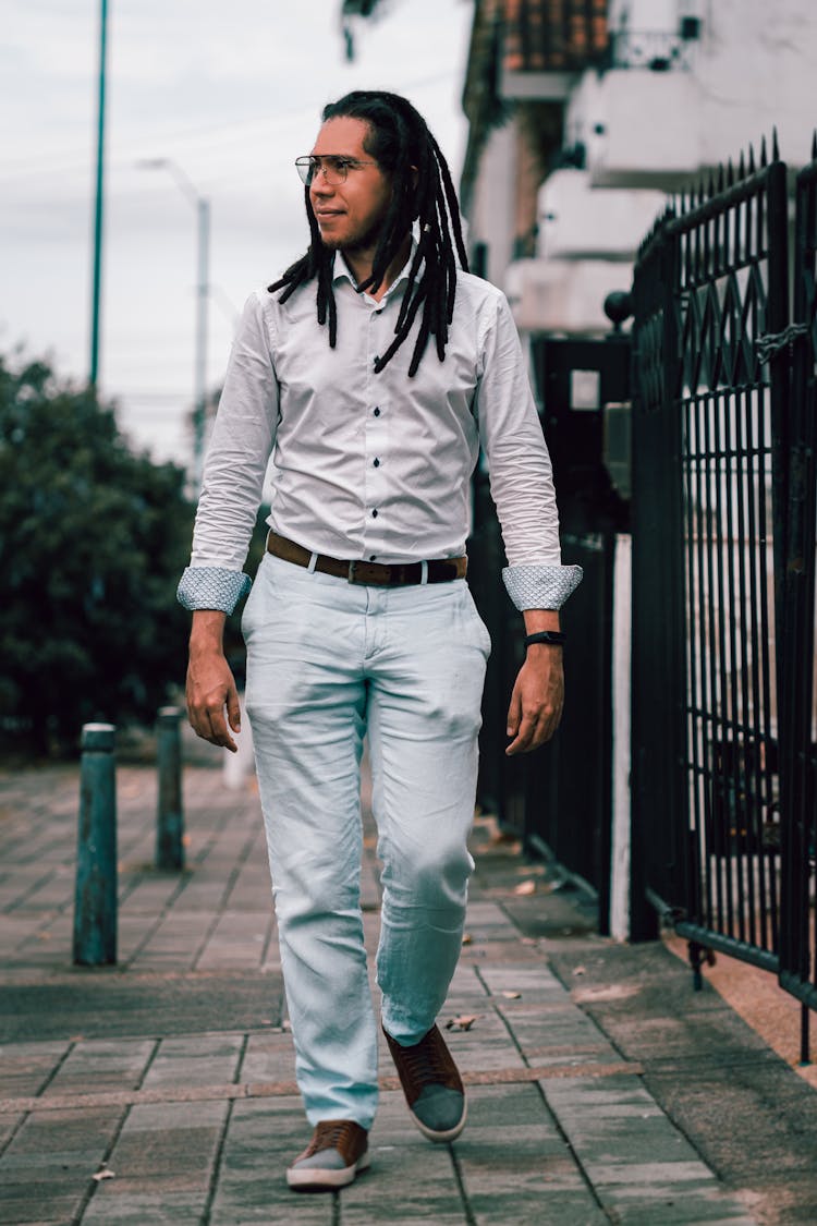 Man In White Dress Shirt And Gray Pants Walking On Sidewalk