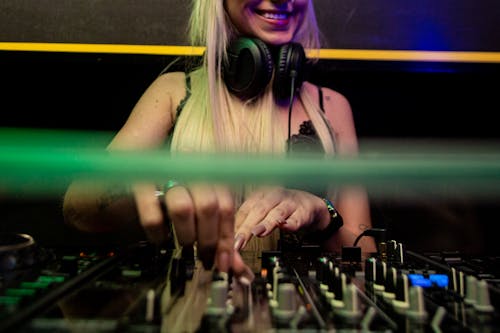 Blonde Woman Using Sound Mixer on Stage