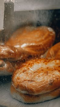 Close-up of wrapped pastries through glass, highlighting fresh baked goods