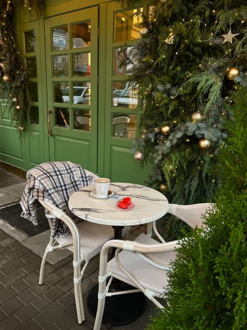 Free Outdoor café with Christmas decor in Odesa, featuring a marble table and holiday ambiance. Stock Photo