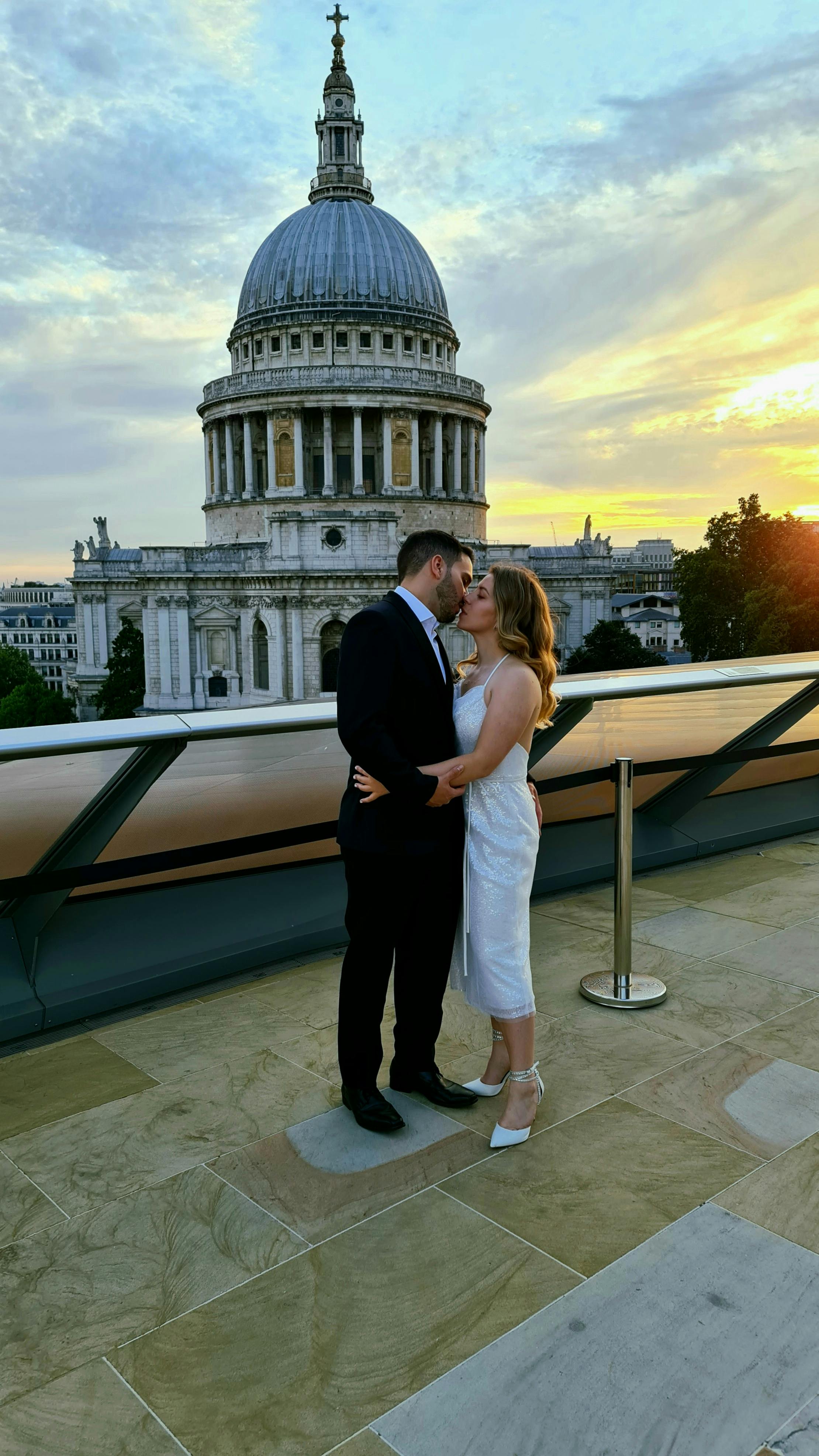 photo of a man kissing a woman in a white dress