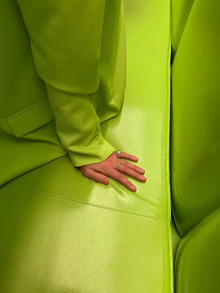 Person In Green Suit Sitting On Neon Green Couch