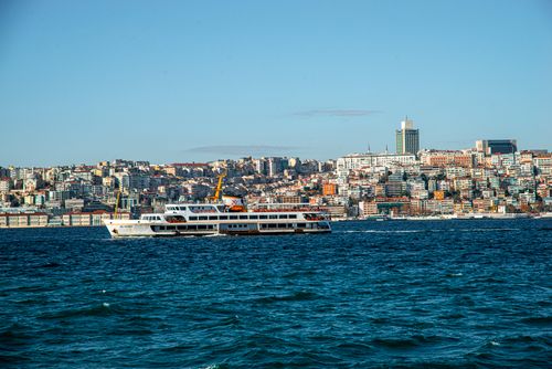 Free Scenic view of a ferry navigating the Bosphorus with Istanbul in the background under a clear sky. Stock Photo