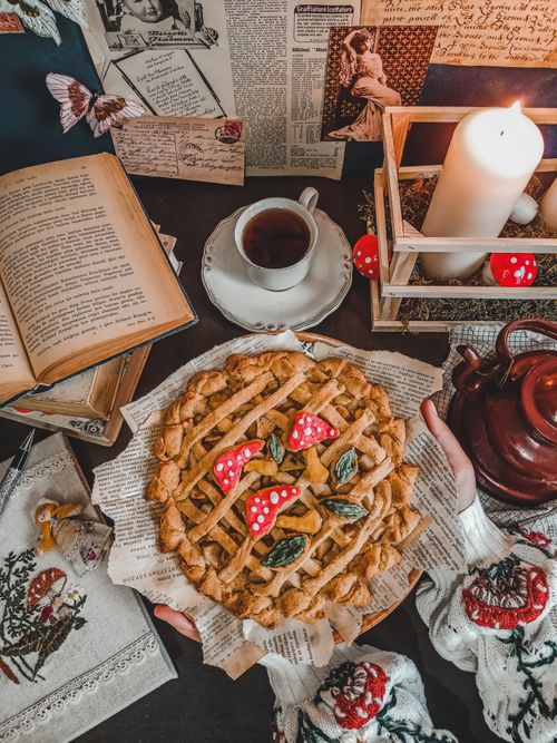 Free A charming vintage dessert scene with a pie, tea, and candlelight. Perfect for nostalgic food photography. Stock Photo