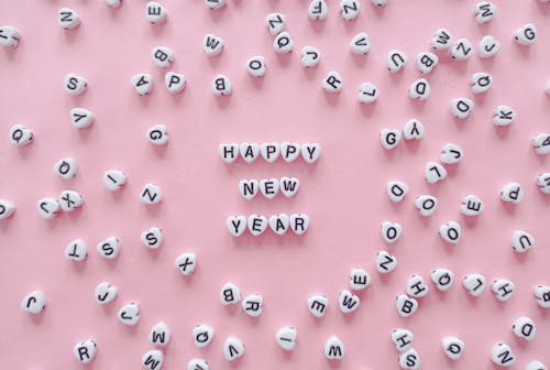 A Happy New Year Greeting Spelled with Heart Shaped Letter Tiles  