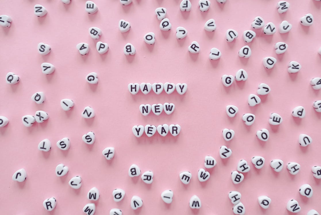 Free A Happy New Year Greeting Spelled with Heart Shaped Letter Tiles   Stock Photo