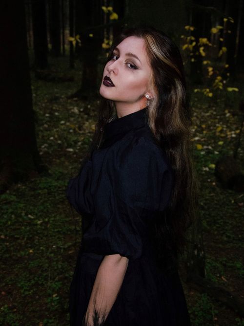 Free A woman with dark lipstick poses in a mystical forest setting in Moscow. Stock Photo