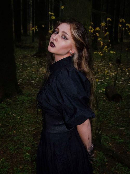Free A woman with dark makeup poses in a Moscow forest, exuding a gothic vibe. Stock Photo