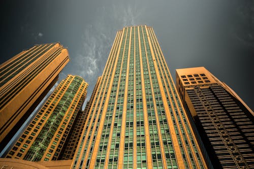 Yellow Concrete Building Under Dark Sky during Night Time