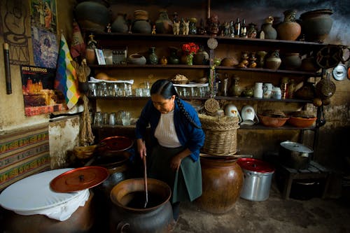 Photo of a Woman Cooking on a Large Pot
