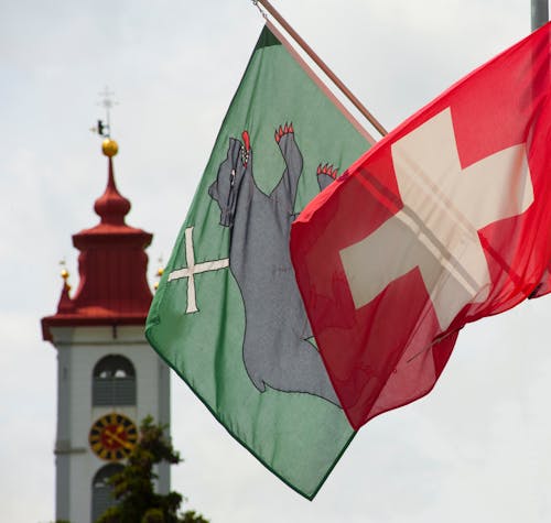 Close-up of Flags and a Tower in the Background 