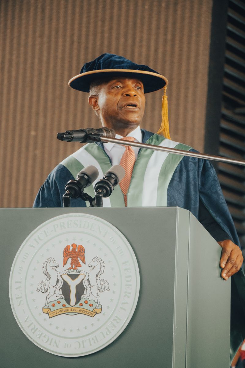 Nigerian official delivering a commencement speech at a university ceremony in formal academic attire.