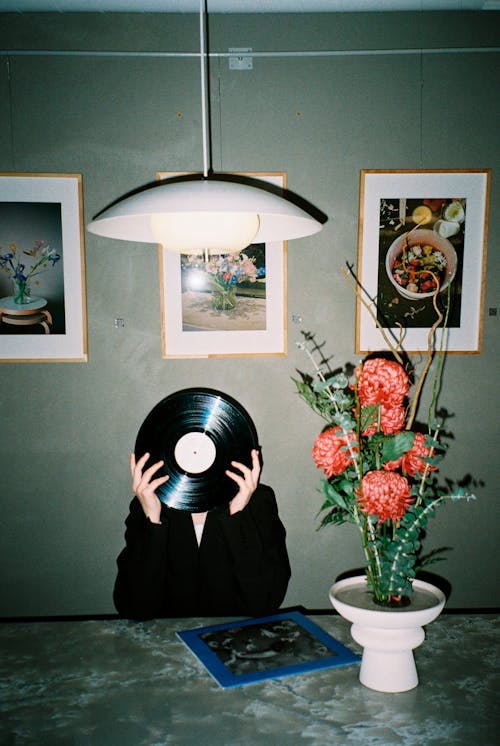 Free Person Holding Vinyl Record Covering Their Face Stock Photo