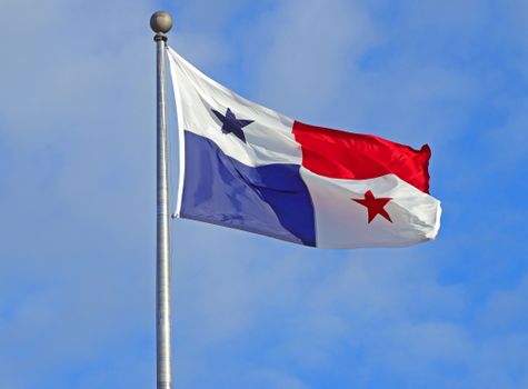 Panama flag waving against a clear blue sky, symbolizing patriotism and national pride.