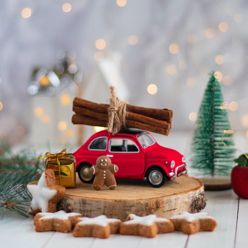 Photo of a Gingerbread Man Near a Toy Car