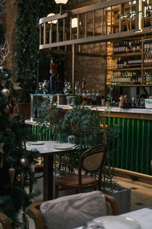 Free Charming pub interior adorned with Christmas decorations and warm lighting creating a festive atmosphere. Stock Photo