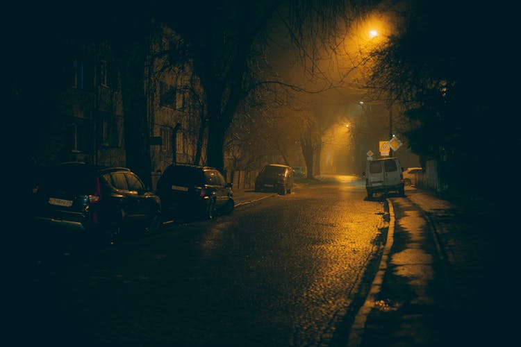 Cars Parked On Side Of The Street During Night Time