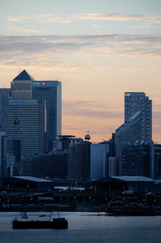 Captivating view of London's cityscape at sunrise, featuring iconic high-rise buildings and vibrant colors.