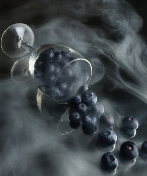 Blueberries on Wine Glass With Smoke 