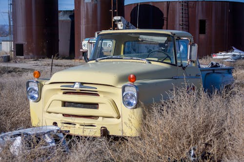 Abandoned Vintage Car on Brown Grass