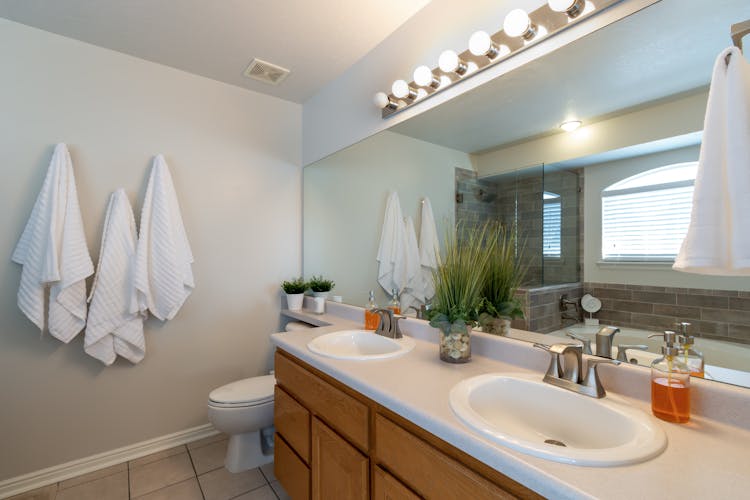 White Towels Hanging Inside A Bathroom 