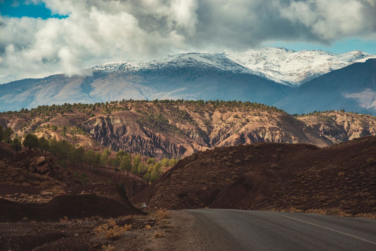 Snow-capped Atlas mountains beyond a valley