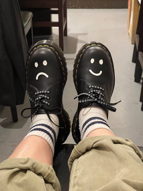 Photo of a Person Wearing Shoes with Drawings