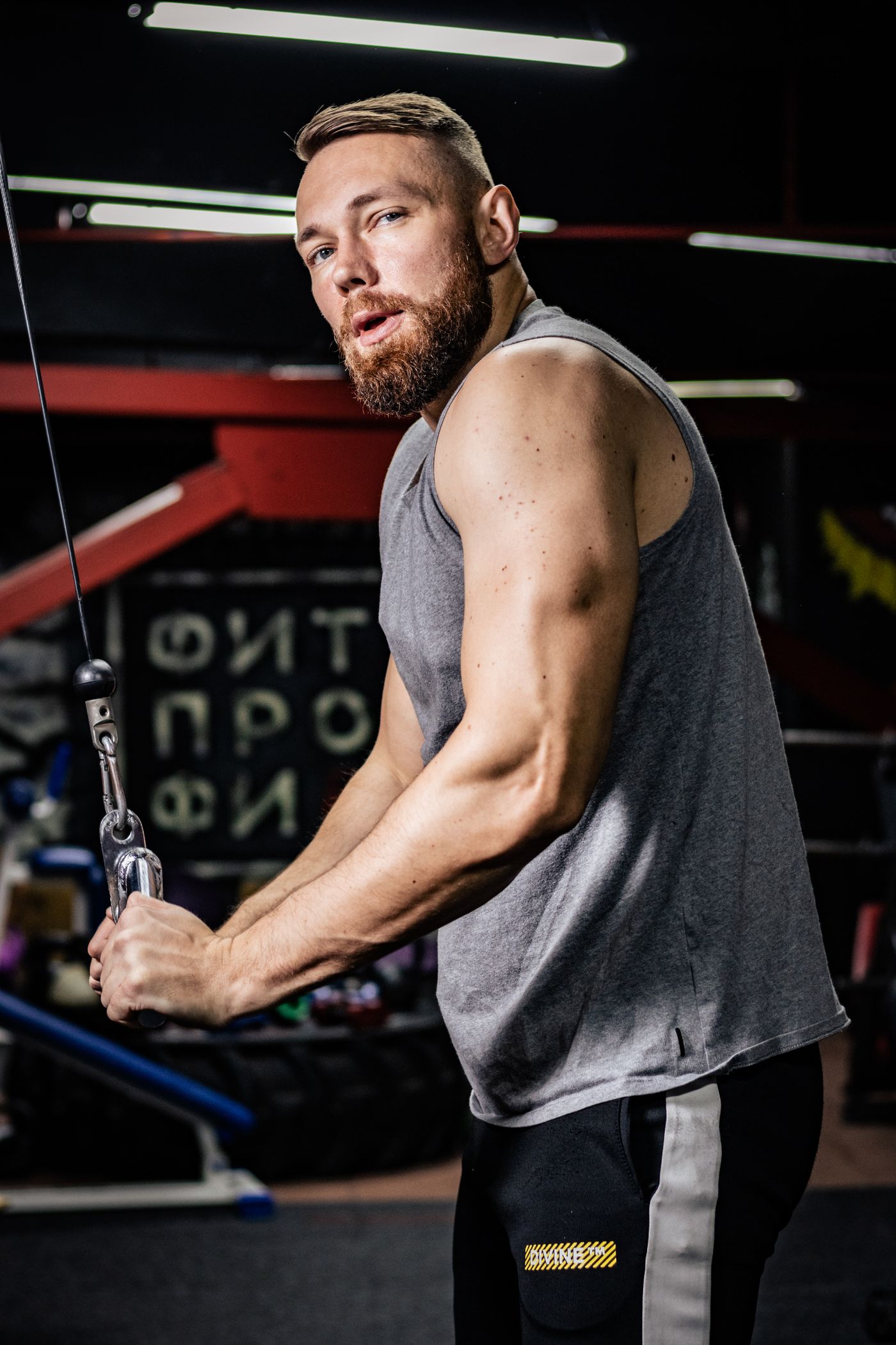 Muscular male trainer exercising in a gym