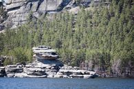 Green Trees Beside a Rock Mountain Near Body of Water