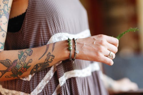 Person With Arm Tattoo Wearing Bracelets 