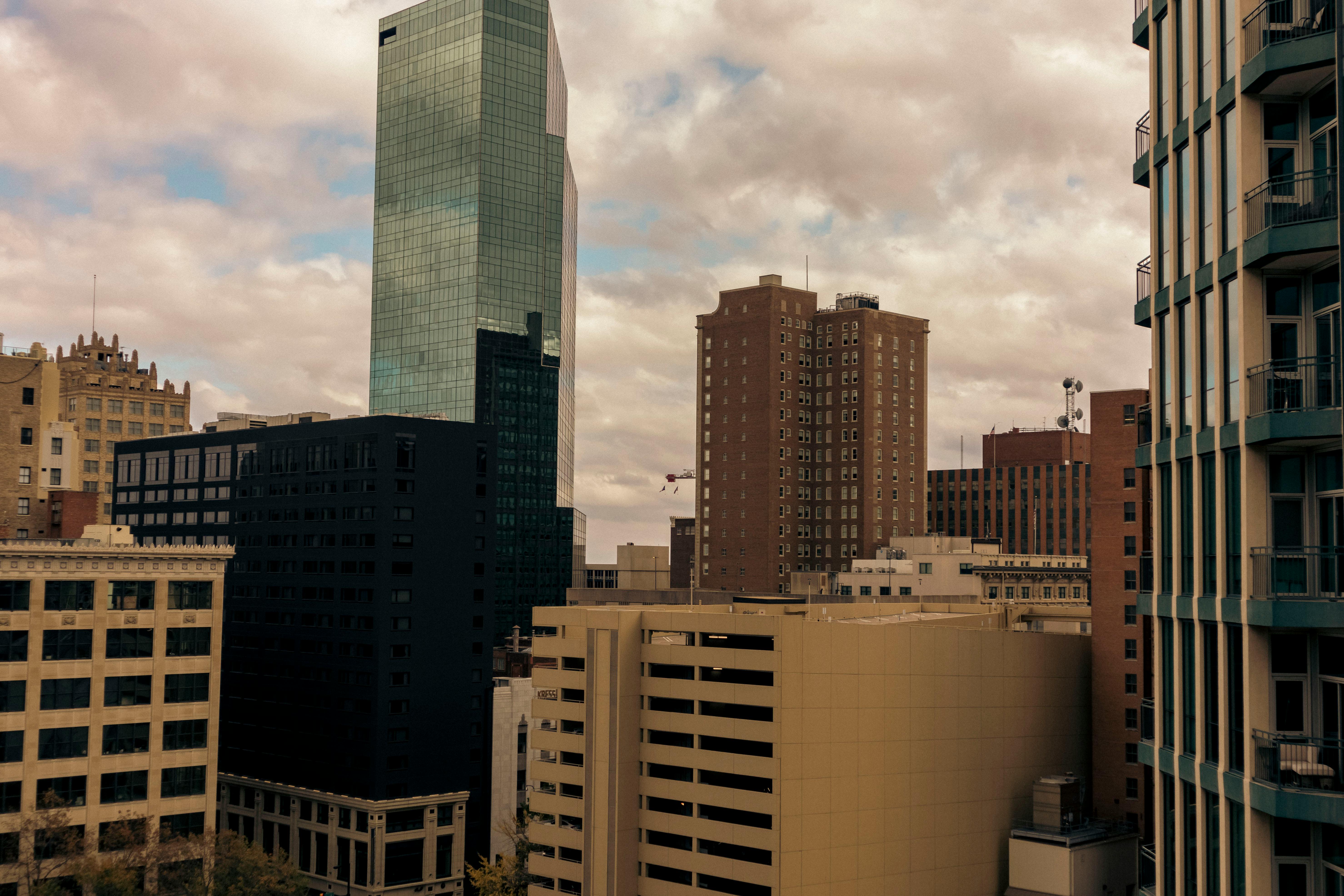 city buildings under white clouds