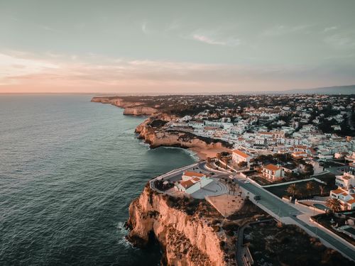 Free A stunning aerial view of Algarve's cliffs and coastlines at sunset, showcasing Faro District's scenic beauty. Stock Photo
