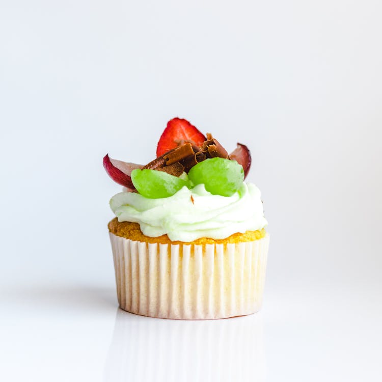 Cupcake with Whipped Cream and Fruits on Top 