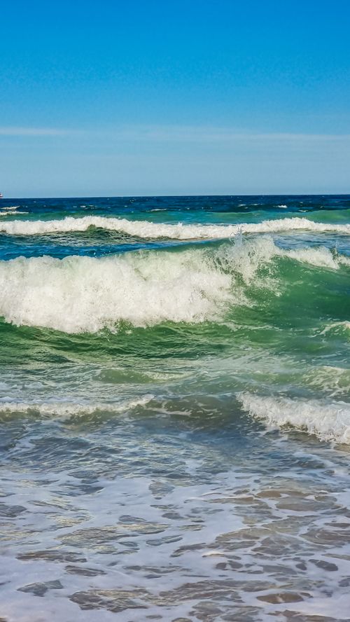 Beach Waves Crashing on Sand Under the Blue Sky · Free Stock Photo